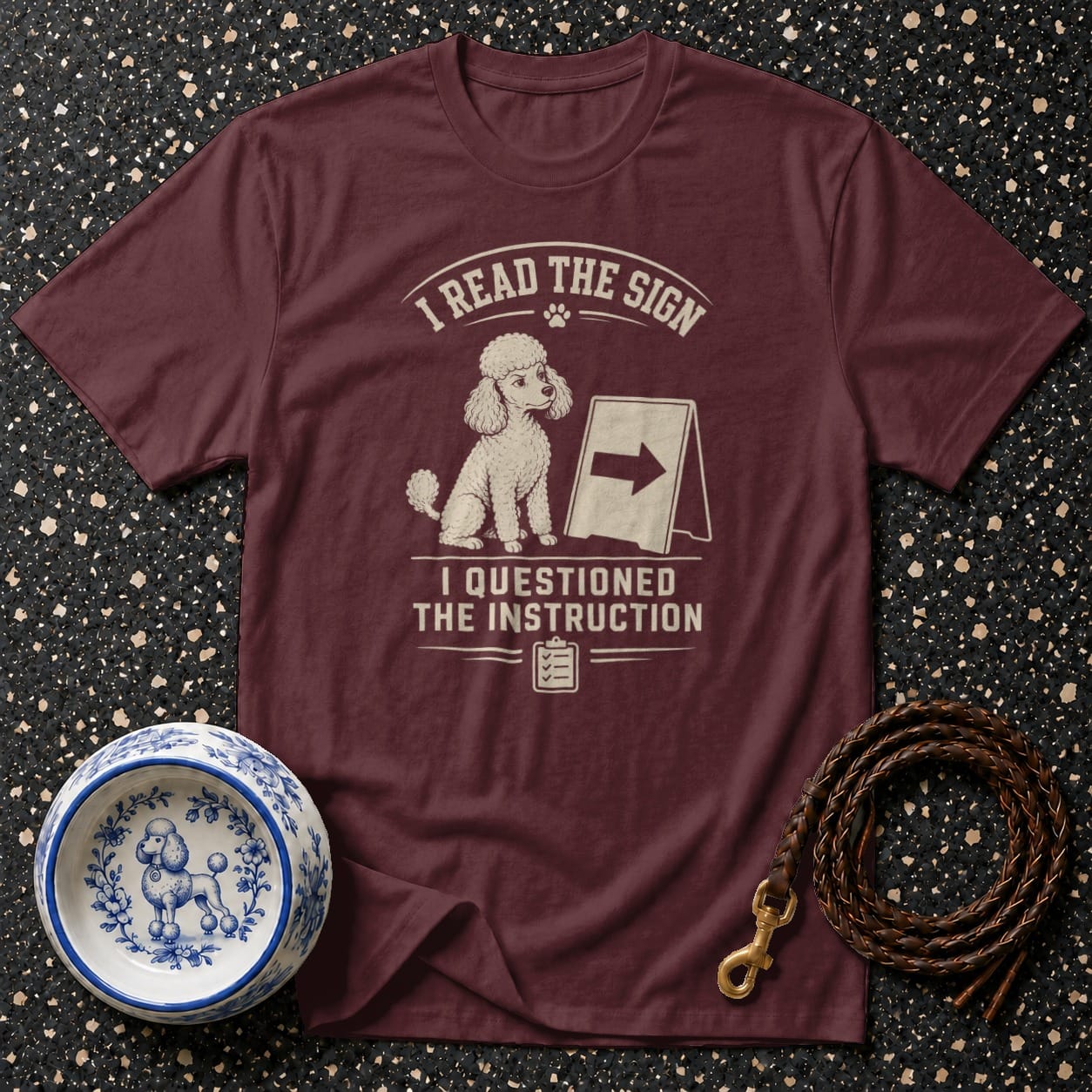 Maroon t-shirt with poodle graphic and text "I READ THE SIGN I QUESTIONED THE INSTRUCTION".
