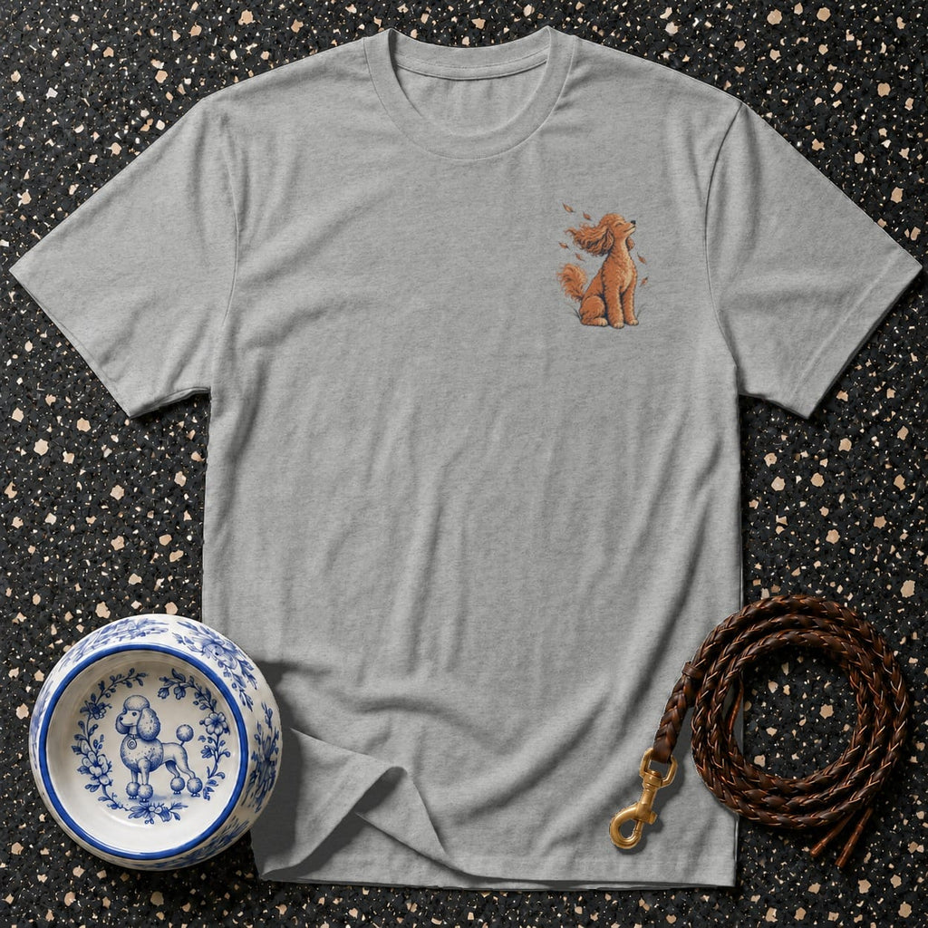 Grey t-shirt with embroidered sitting poodle and falling leaves design.