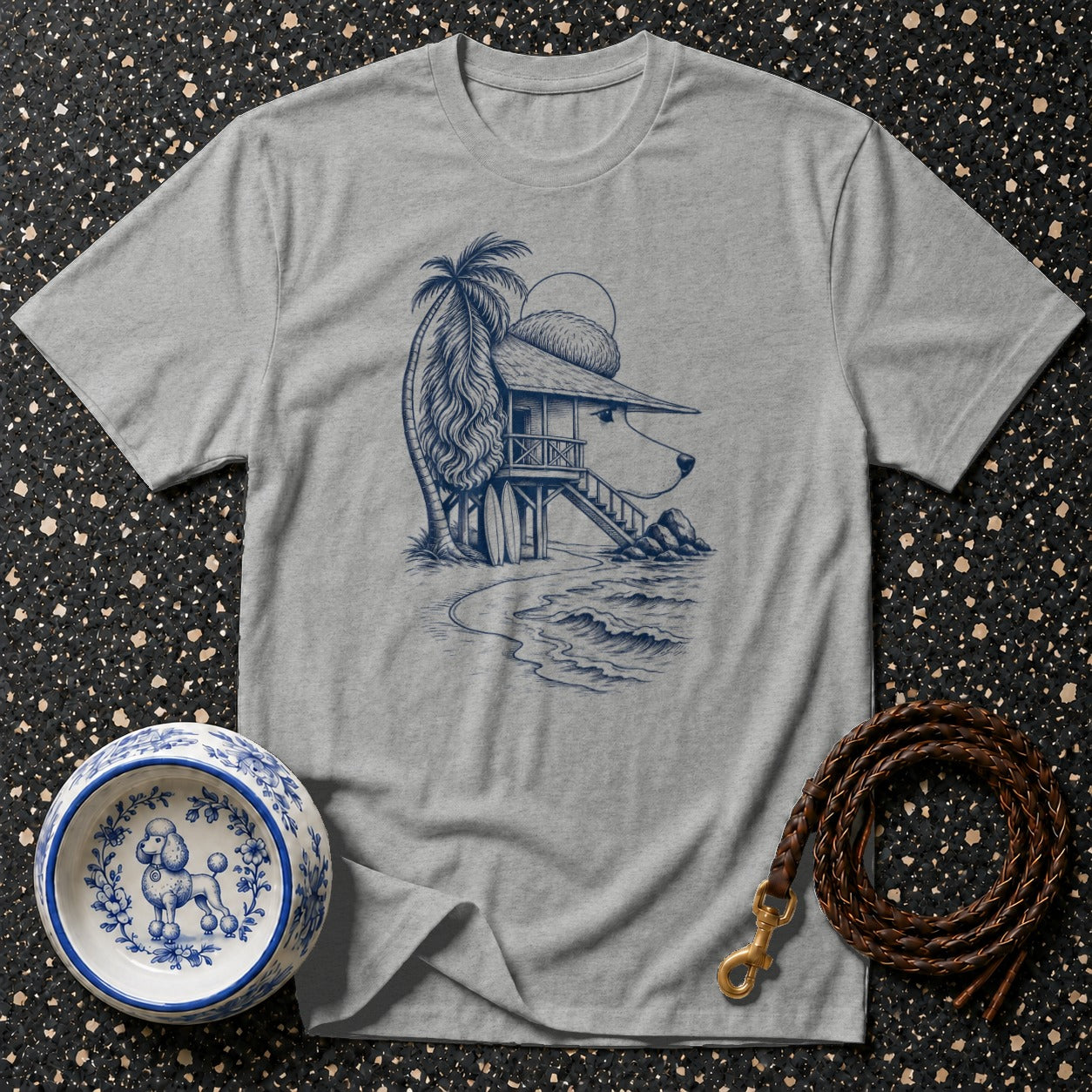 Grey t-shirt with a blue line drawing of a dog-shaped beach house with a palm tree.
