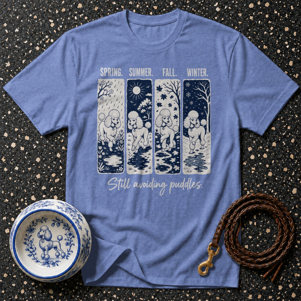 Blue t-shirt with four panels depicting poodles in spring, summer, fall, and winter.