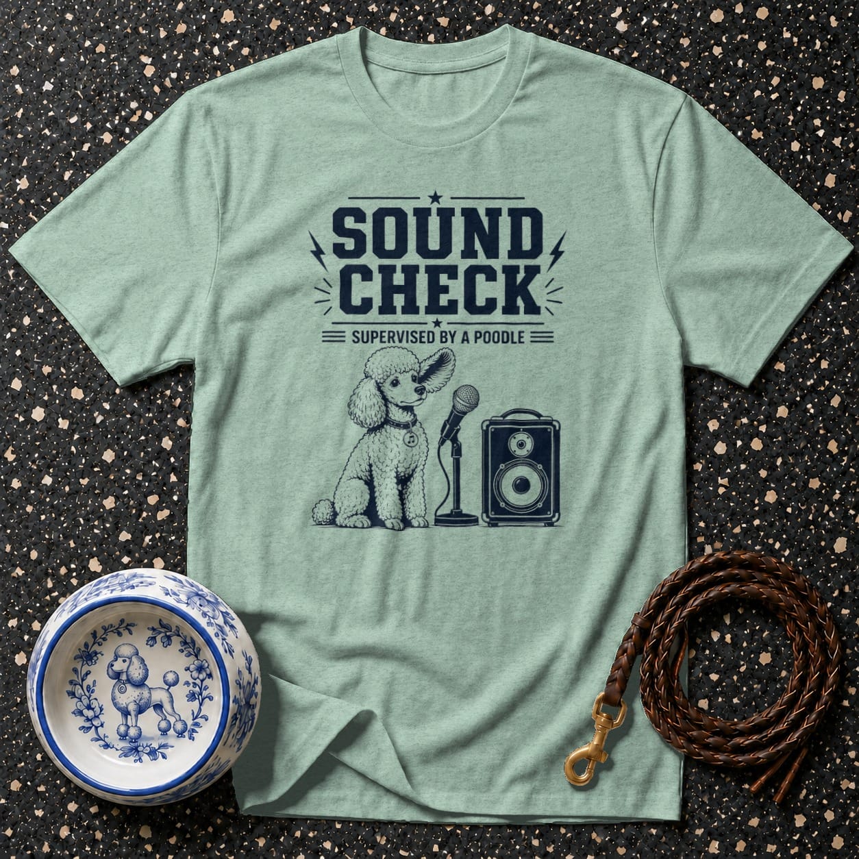 Light green t-shirt with a poodle, microphone, and speaker graphic reading "Sound Check".