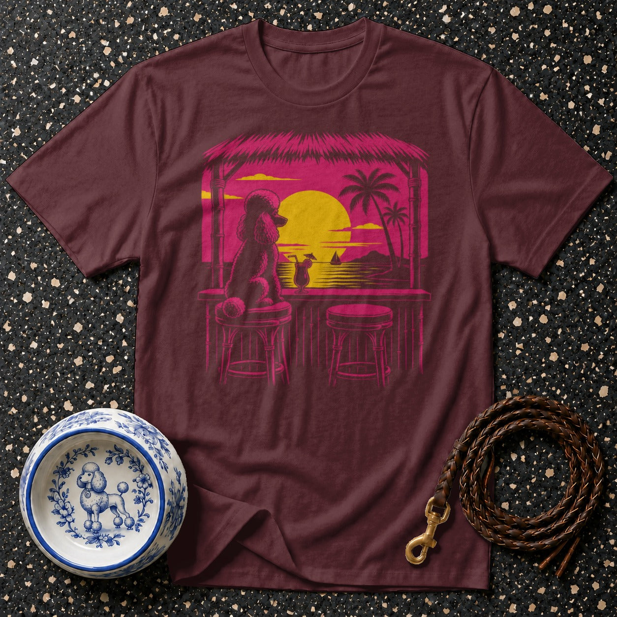 Maroon t-shirt with a poodle at a tropical bar at sunset graphic.