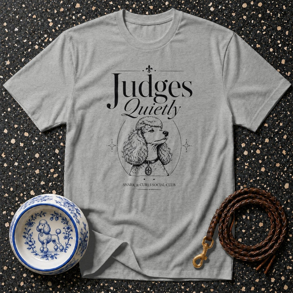 Grey t-shirt with "Judges Quietly" text and poodle illustration, with dog bowl and leash.