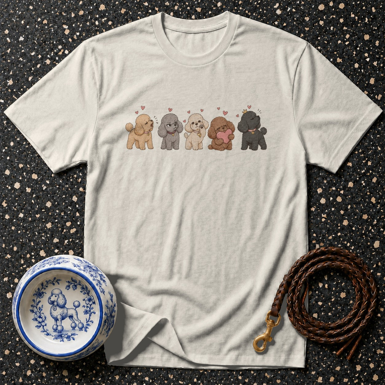 Cream t-shirt with a line of five cartoon poodles and tiny hearts.