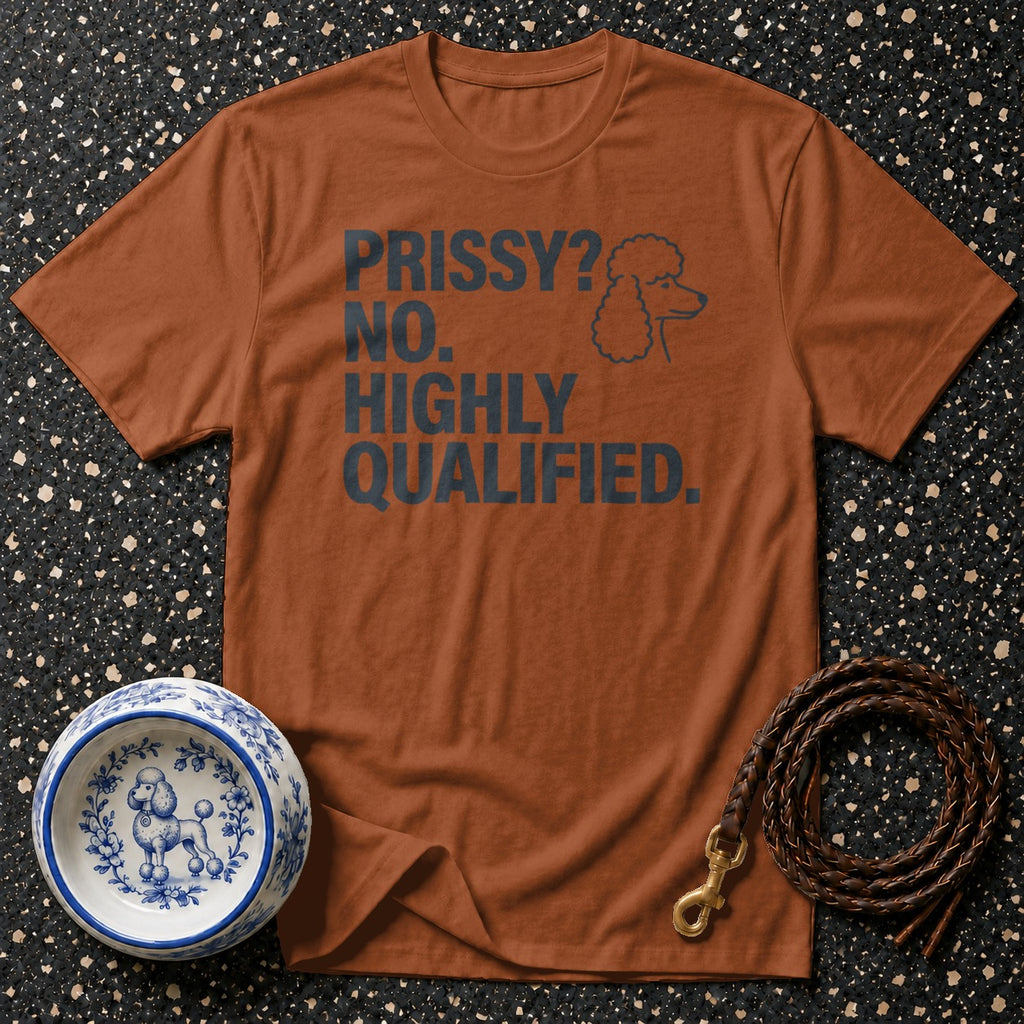 Brown t-shirt with "PRISSY? NO. HIGHLY QUALIFIED." text and poodle graphic.