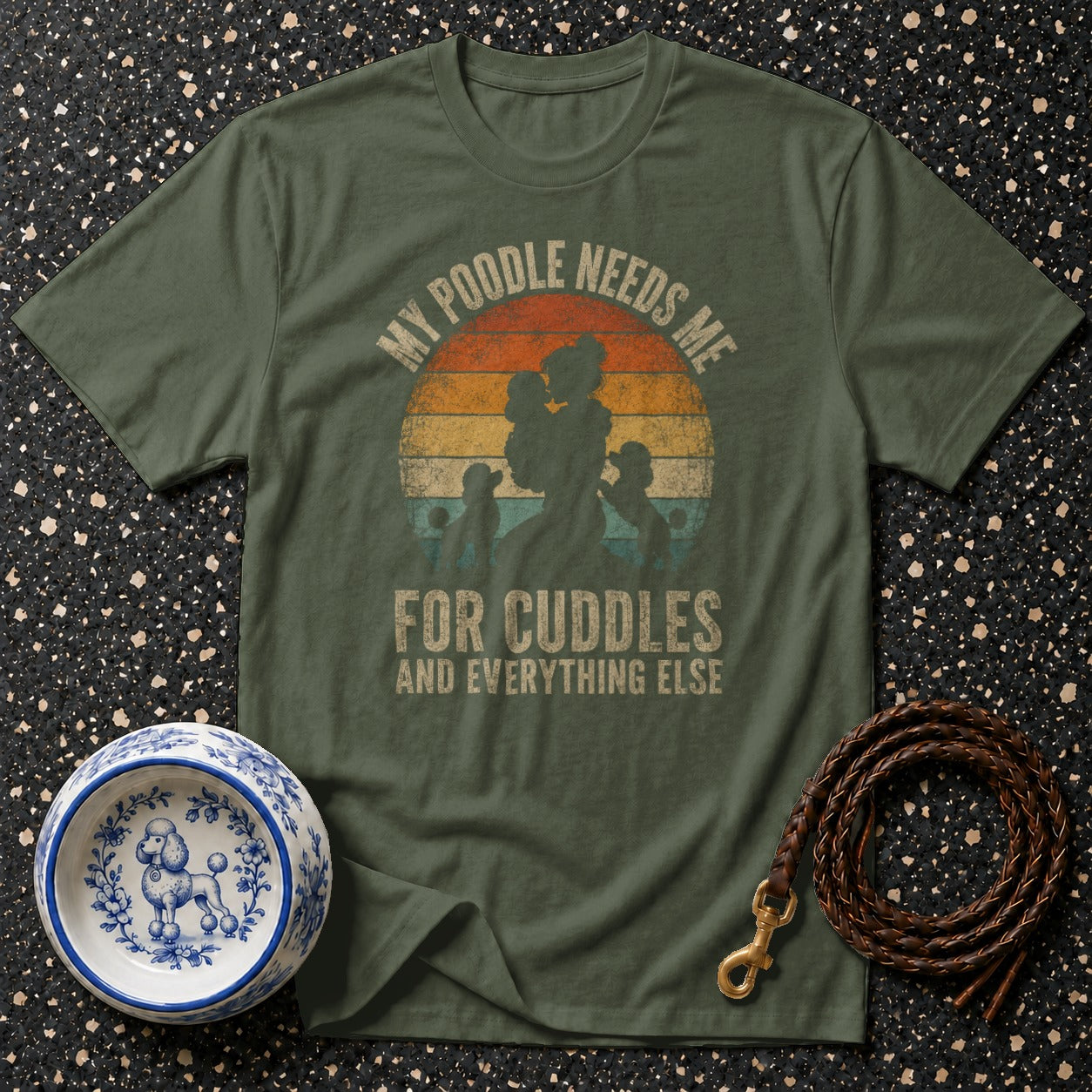 Olive green t-shirt with "My poodle needs me for cuddles and everything else" graphic.