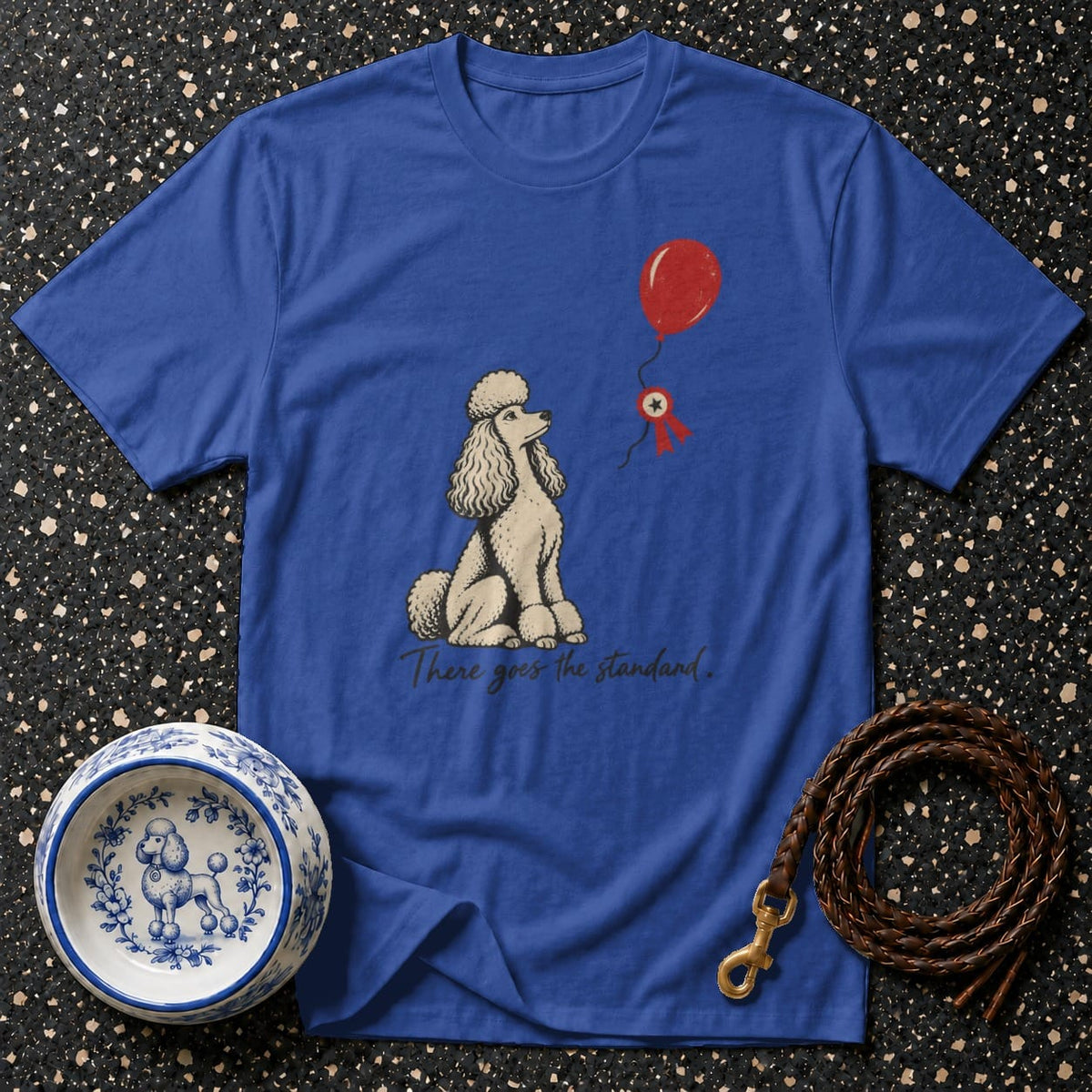 Blue t-shirt with poodle, red balloon, ribbon, and text "There goes the standard."