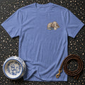Blue t-shirt with a drawing of a poodle on a book with a coffee cup.