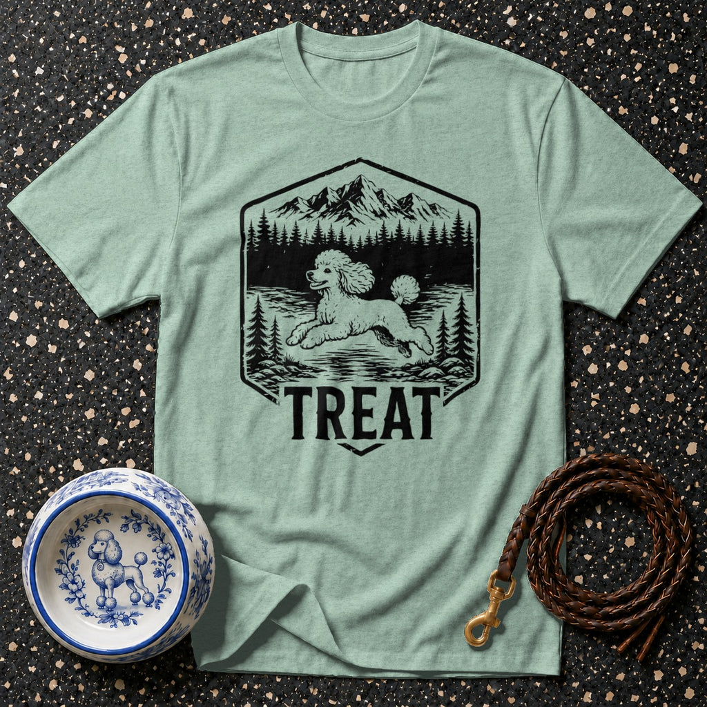 Light green t-shirt with a graphic of a poodle running through a forest with mountains and the word "TREAT".
