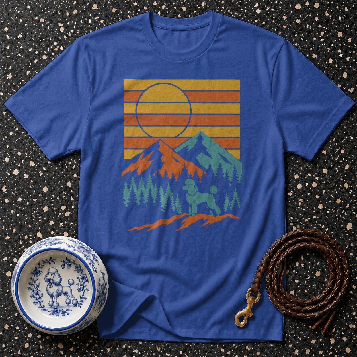 Blue t-shirt with retro mountain landscape and poodle graphic.