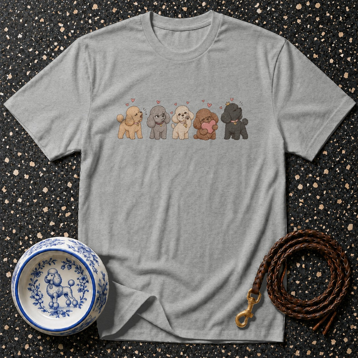 Grey t-shirt with illustration of five poodles and scattered hearts.
