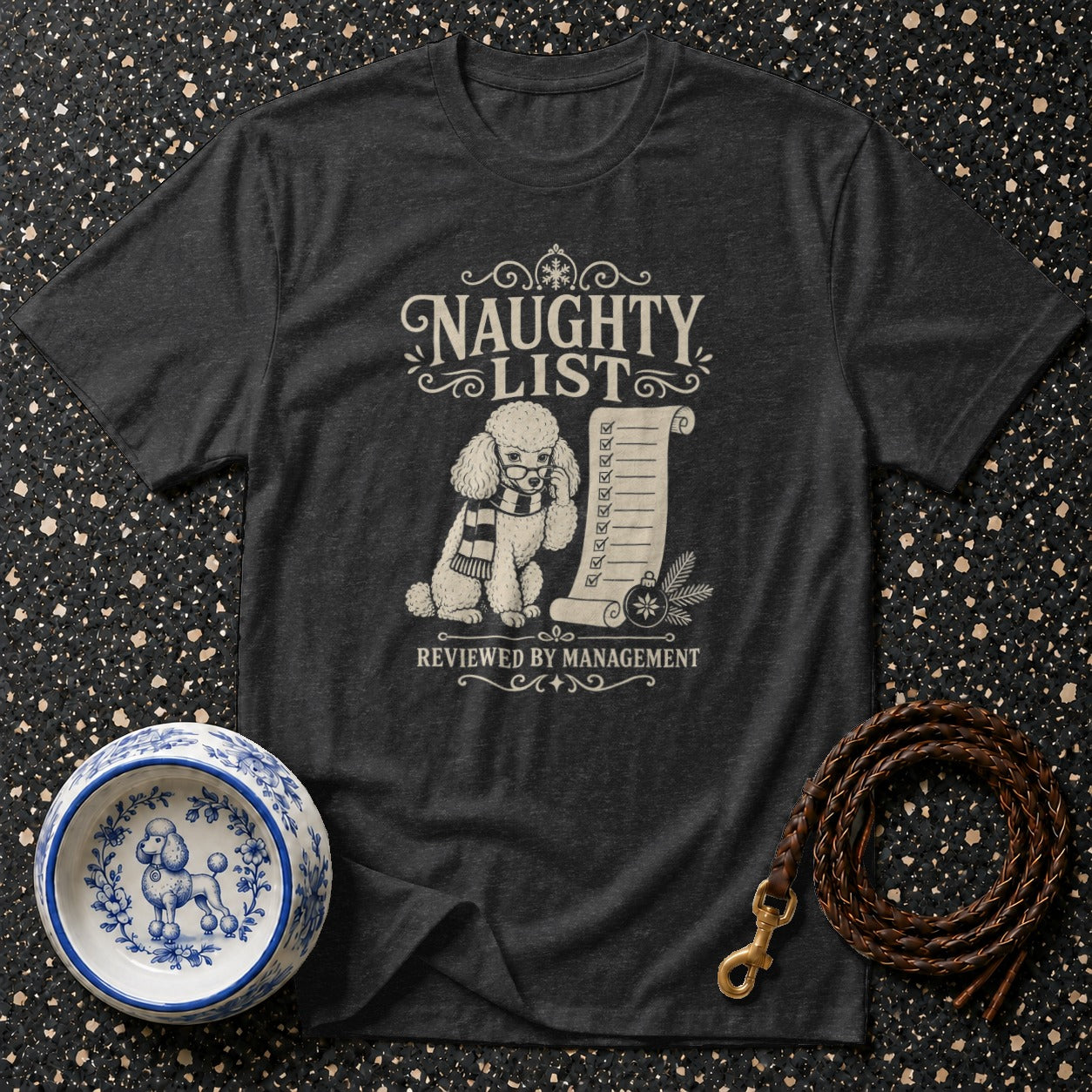 Dark t-shirt with graphic of a poodle, naughty list, and "Reviewed by Management."