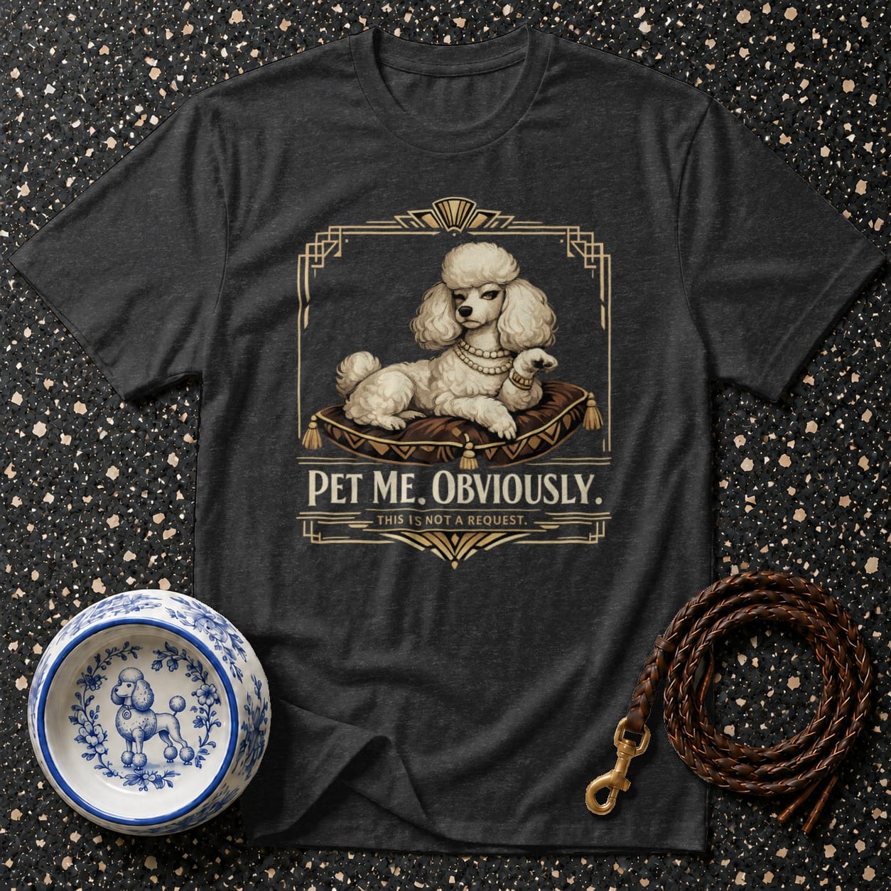 Dark t-shirt with a white poodle on a pillow graphic and text "PET ME. OBVIOUSLY."