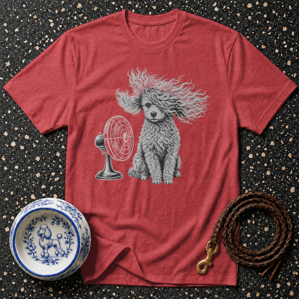 Red t-shirt with a poodle sitting in front of a fan, next to a bowl and leash.