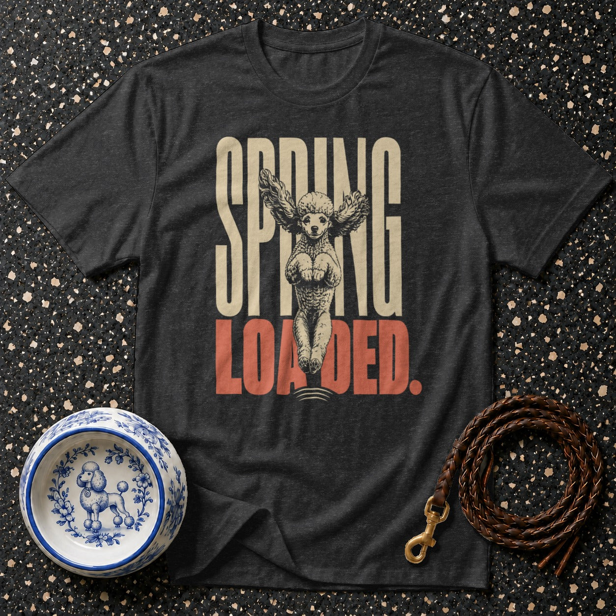 Dark t-shirt with "SPRING LOADED" text and a poodle with wings graphic.