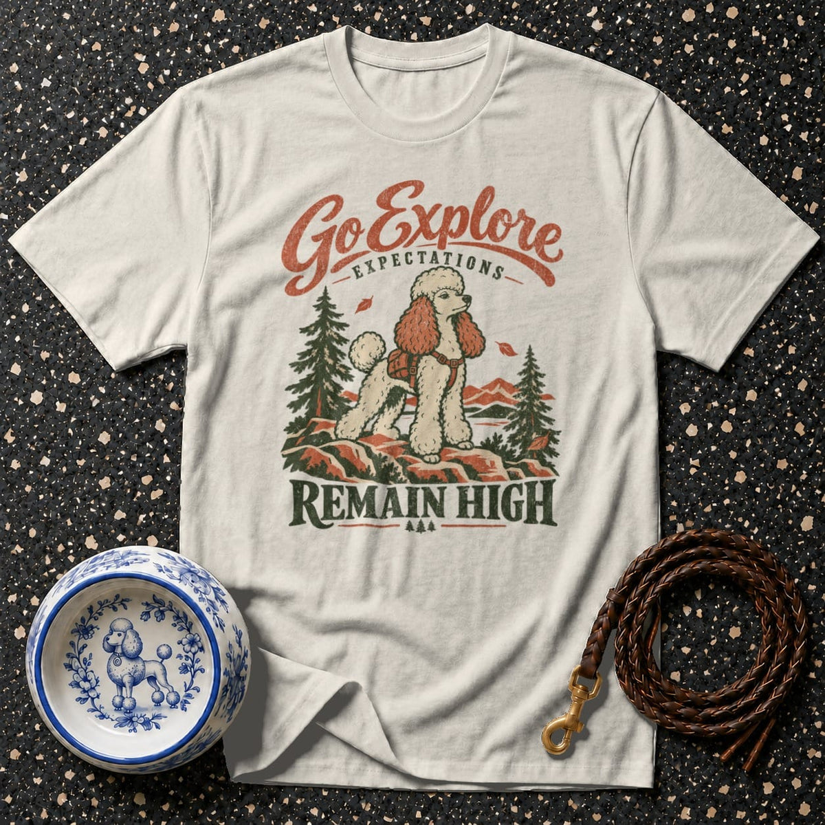 Cream t-shirt with "Go Explore Expectations Remain High" text and poodle hiking graphic.