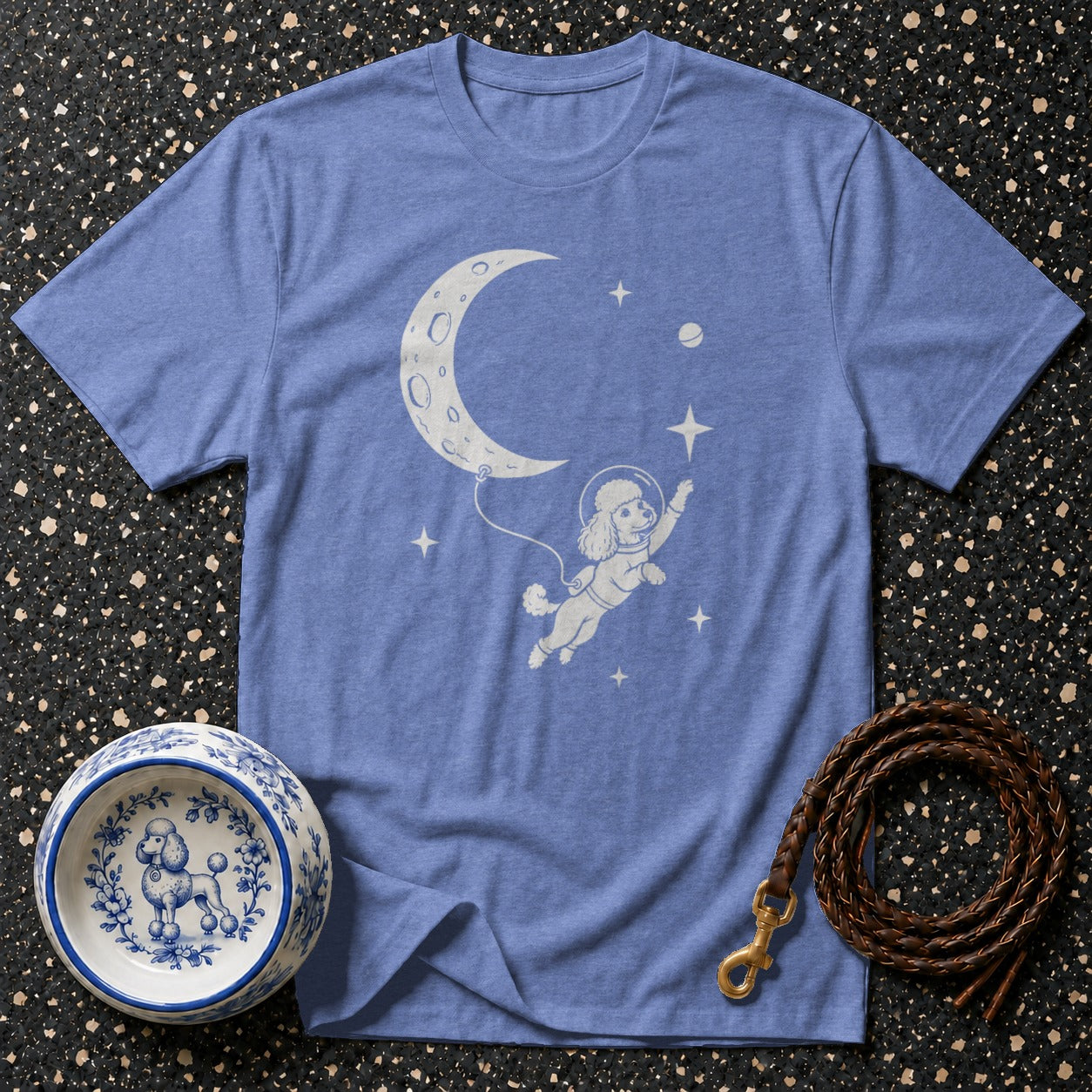 Blue t-shirt with poodle astronaut floating near crescent moon and stars.