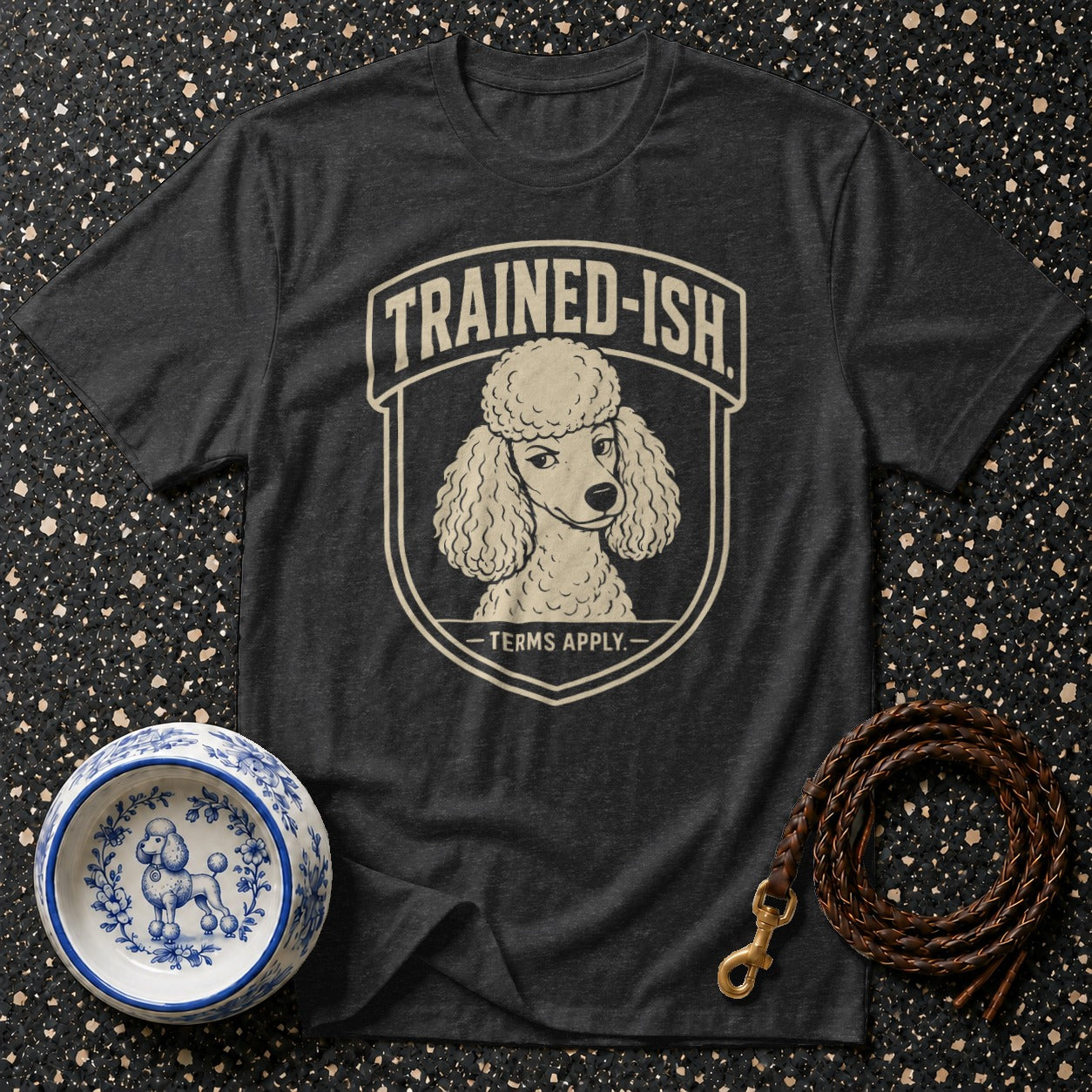 Dark grey t-shirt with a poodle graphic and "TRAINED-ISH TERMS APPLY." text.