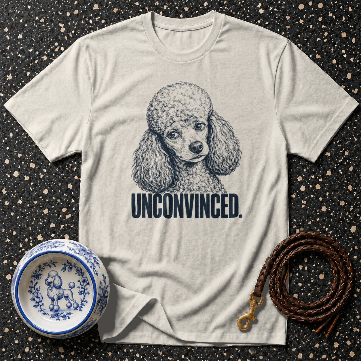 T-shirt with a drawing of a poodle and the text "UNCONVINCED."