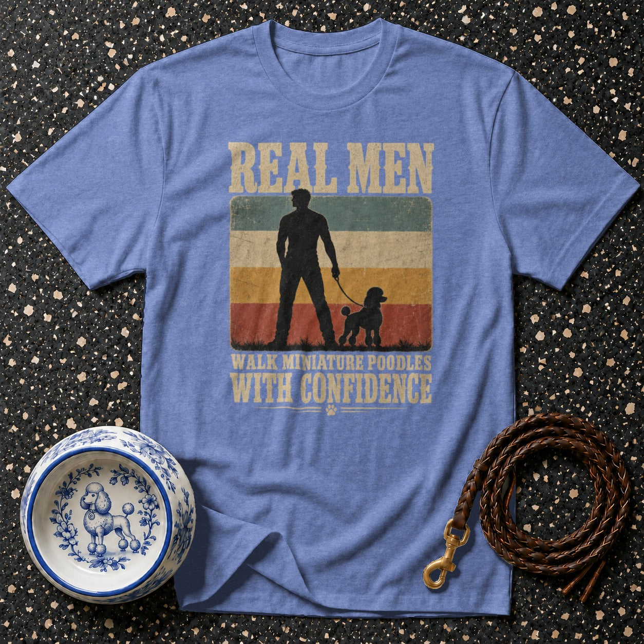 Blue t-shirt with graphic of man and poodle, reading "Real Men Walk Miniature Poodles With Confidence".