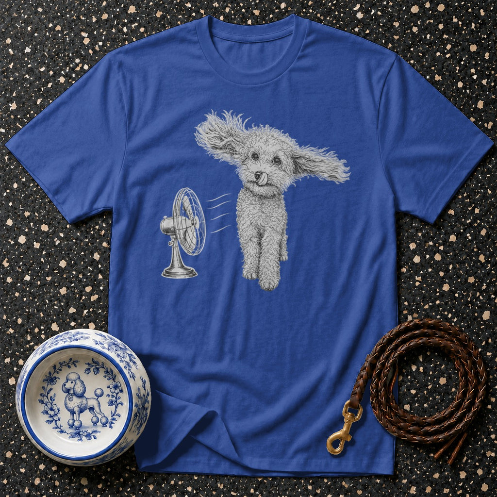 T-shirt with poodle design in front of a fan, dog bowl, and leash.