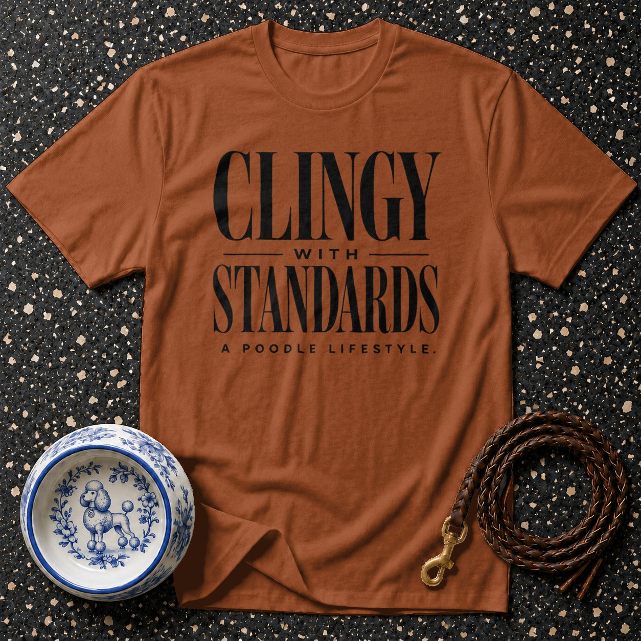 Orange t-shirt with black text "CLINGY WITH STANDARDS A POODLE LIFESTYLE".
