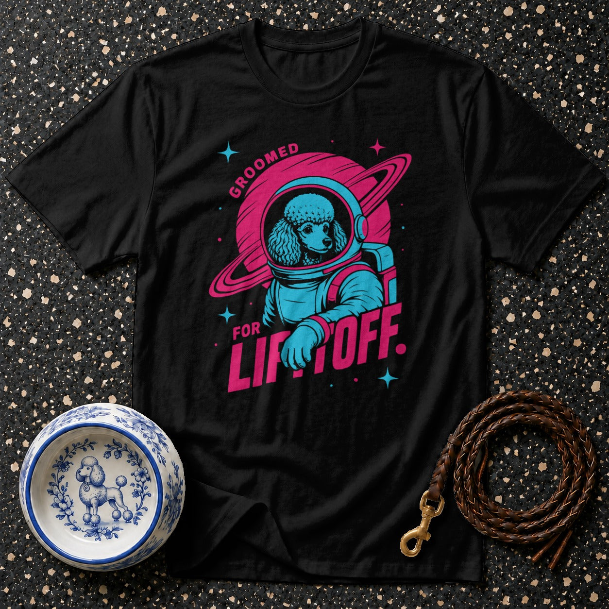 Black t-shirt with poodle astronaut graphic and text "Groomed for Liftoff."