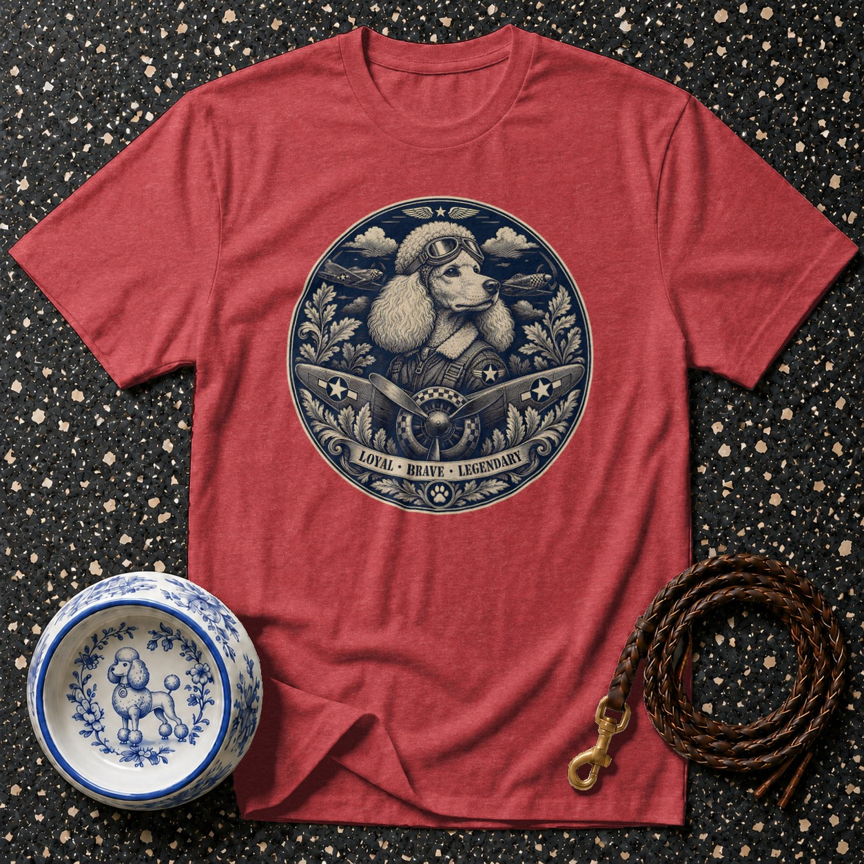 Red t-shirt with a circular graphic of a poodle pilot surrounded by planes and clouds.