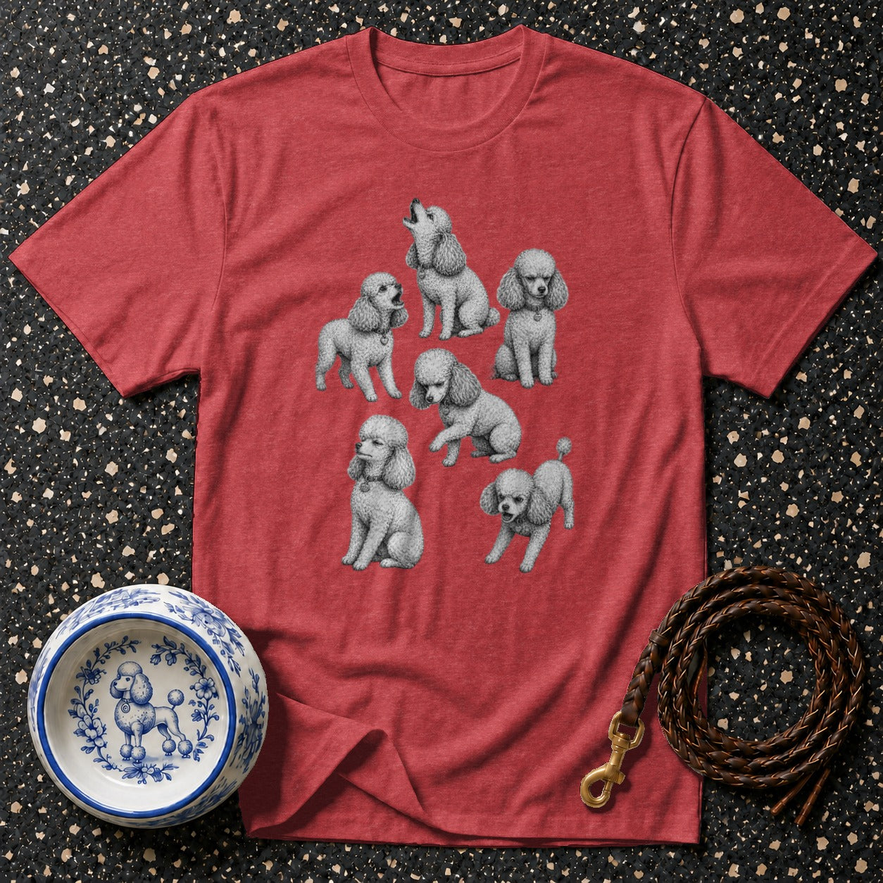 Red t-shirt with a graphic of multiple poodles and a nearby dog bowl and leash.