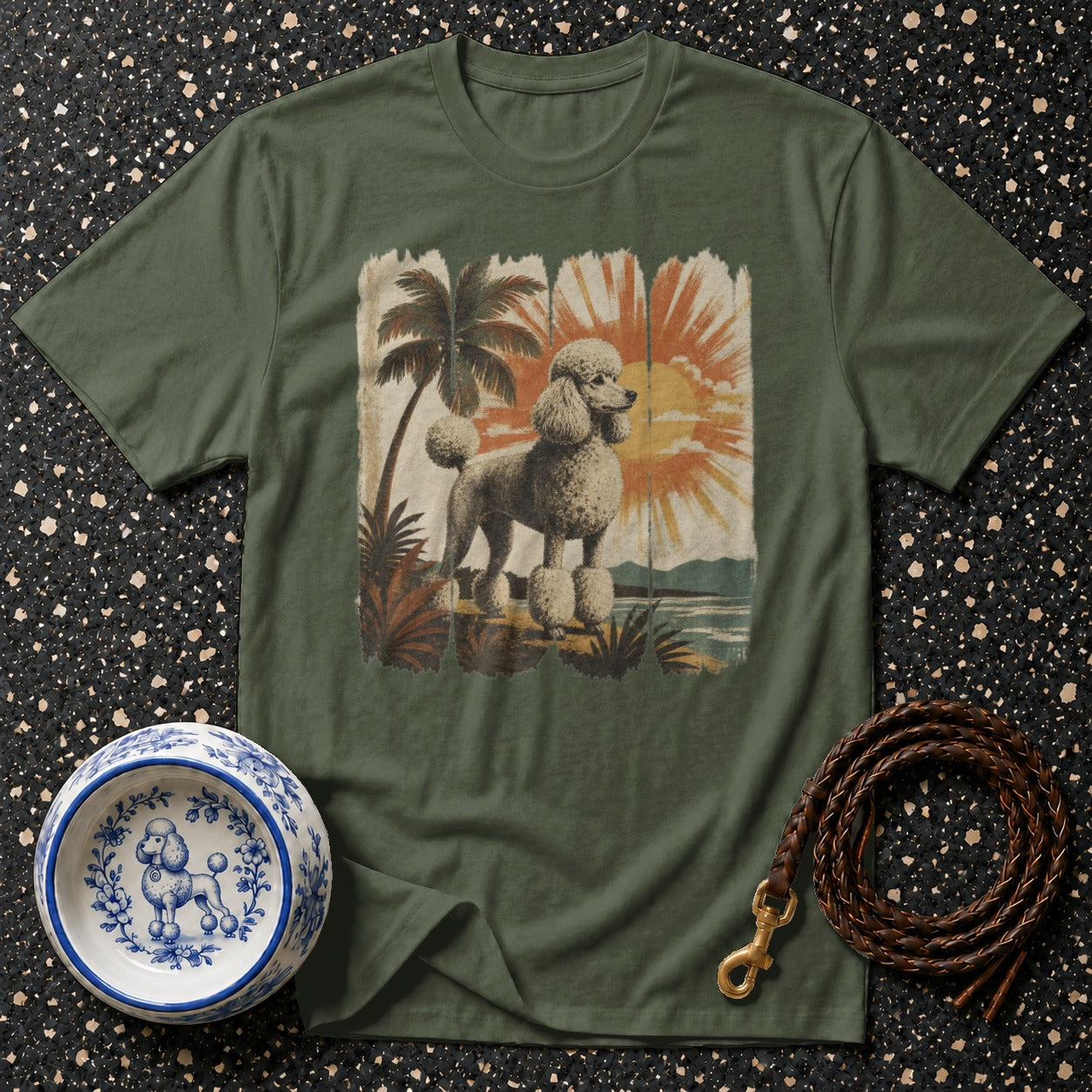 T-shirt featuring a poodle graphic with palm trees and a sunset scene.