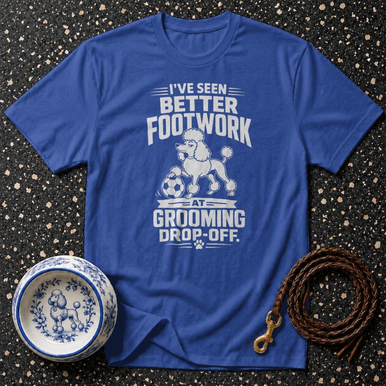 Blue t-shirt with white text and graphics reading "I've Seen Better Footwork, At Grooming Drop-Off".