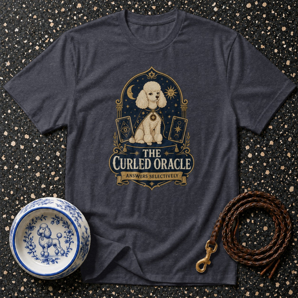 Dark t-shirt with a stylized poodle in a cape, surrounded by astrological symbols and tarot cards, text reads "The Curled Oracle Answers Selectively."