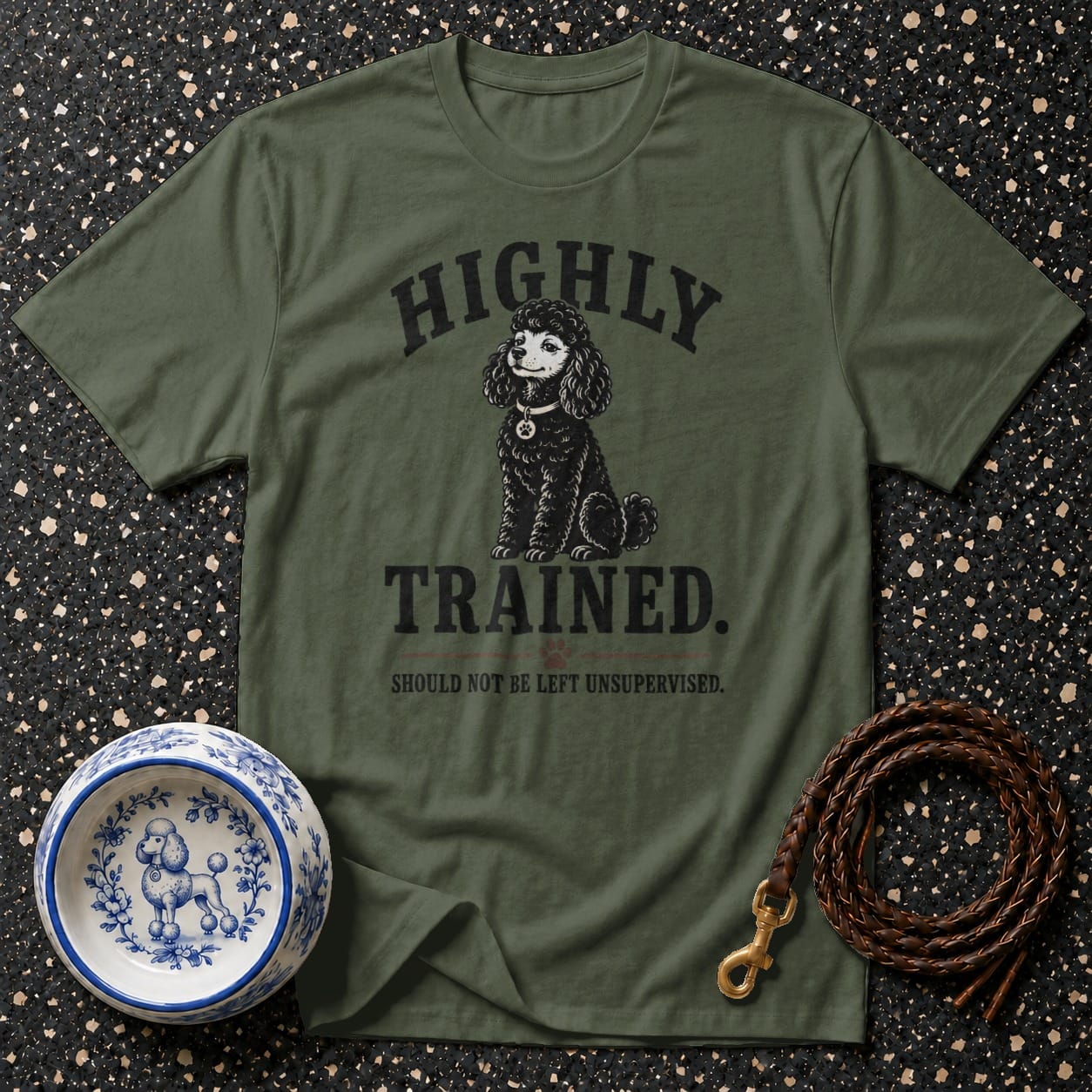 Olive green t-shirt with a black poodle graphic and the text "HIGHLY TRAINED. SHOULD NOT BE LEFT UNSUPERVISED."