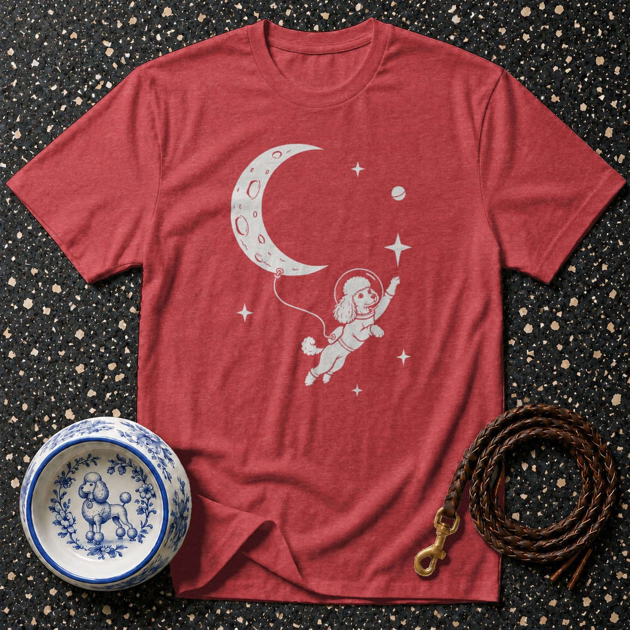 Red t-shirt with a poodle in a spacesuit floating near the moon.