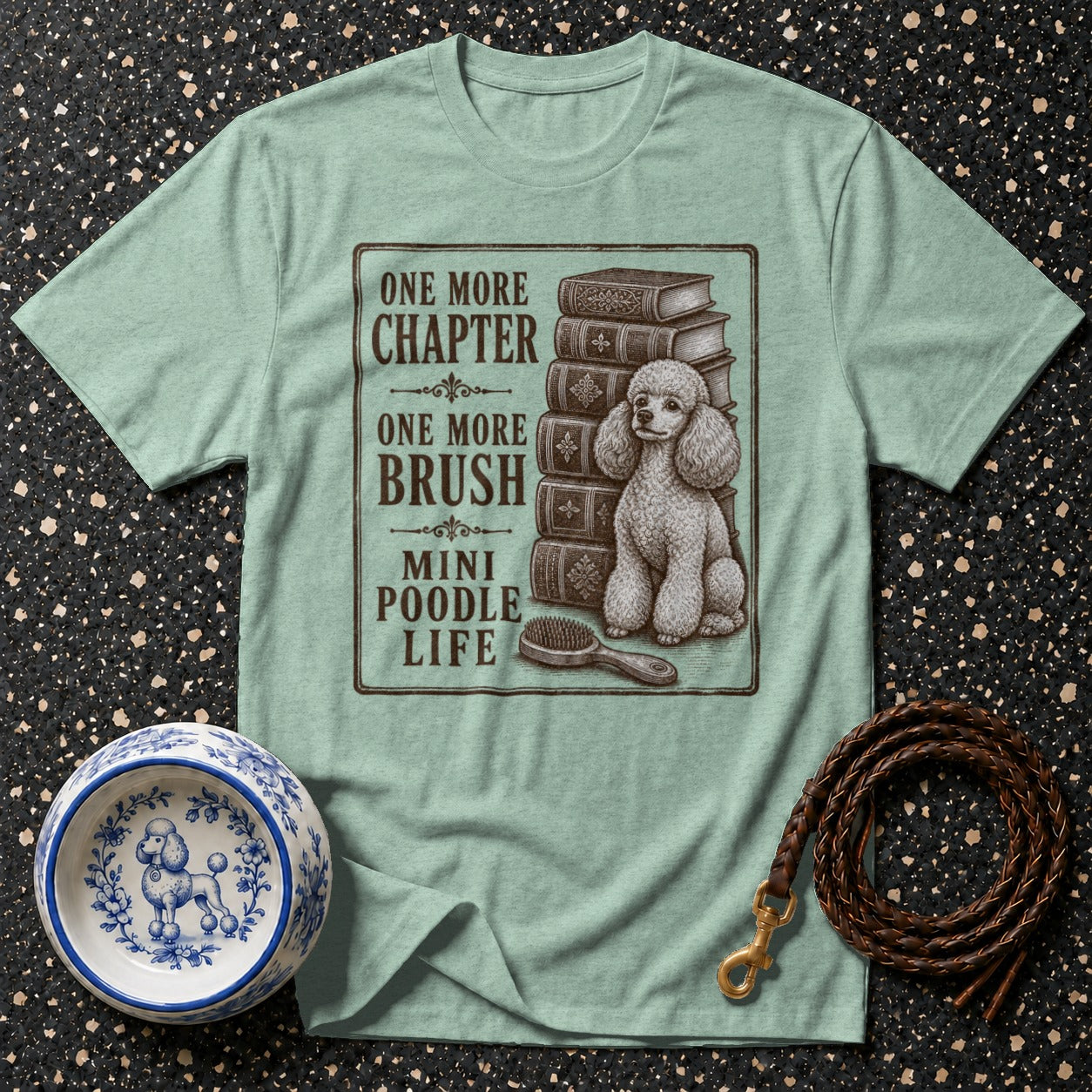 T-shirt with a mini poodle, books, and "One More Chapter, One More Brush, Mini Poodle Life".
