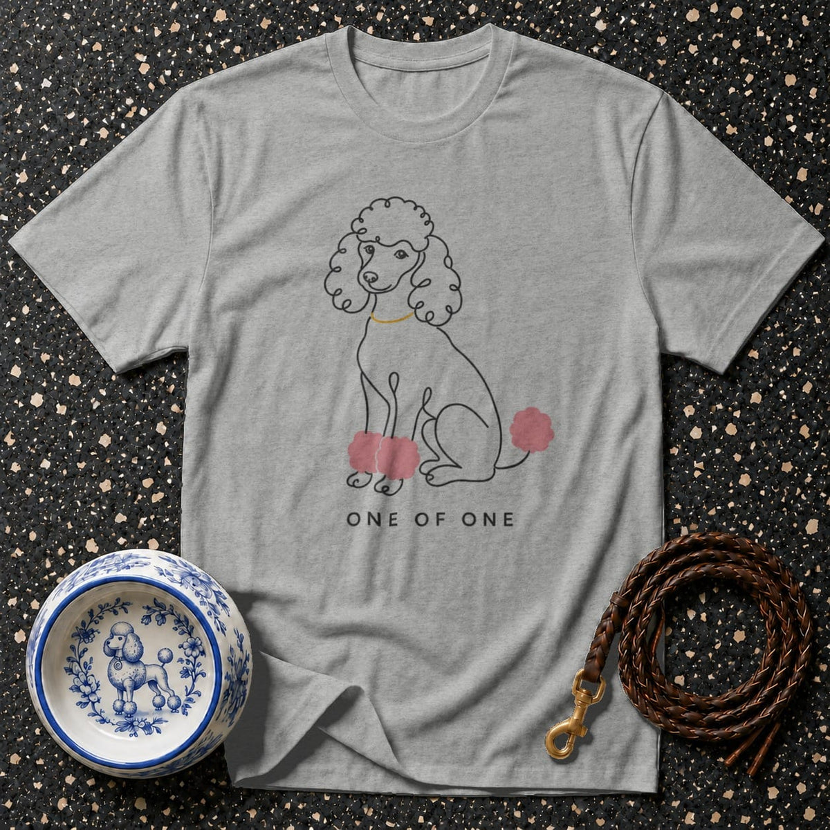 Gray t-shirt with a line drawing of a poodle and text "ONE OF ONE".