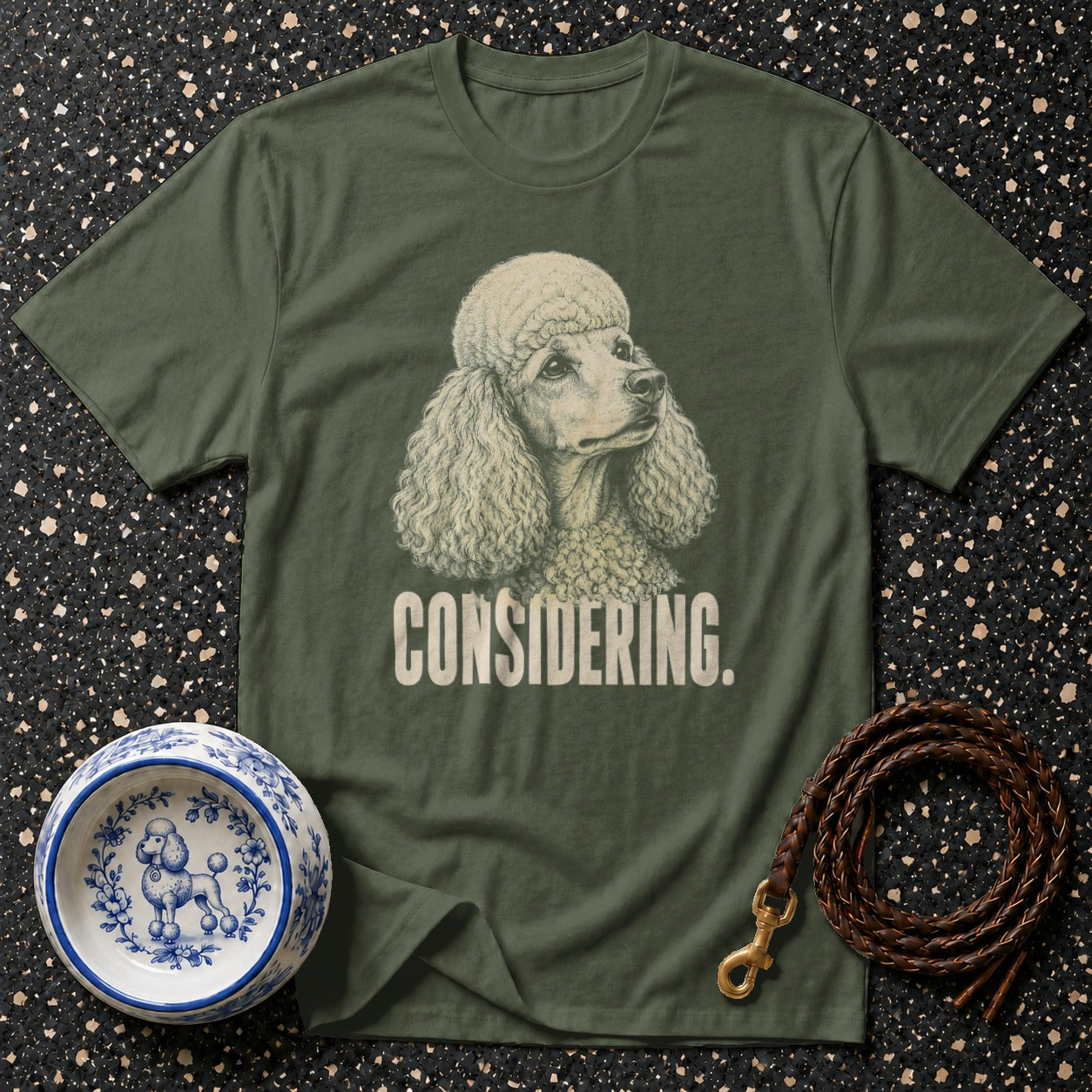 Green t-shirt with poodle graphic and "CONSIDERING." text.