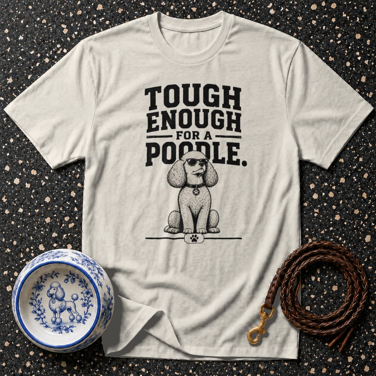 T-shirt with illustration of a poodle wearing sunglasses and the text "TOUGH ENOUGH FOR A POODLE."