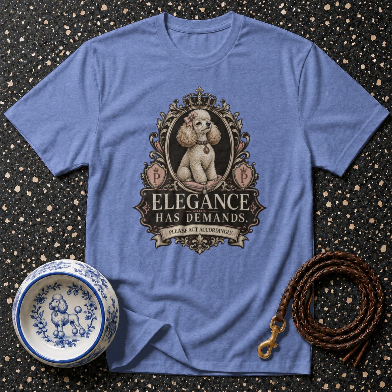 Blue t-shirt with a poodle in an ornate frame and the text "Elegance Has Demands.".