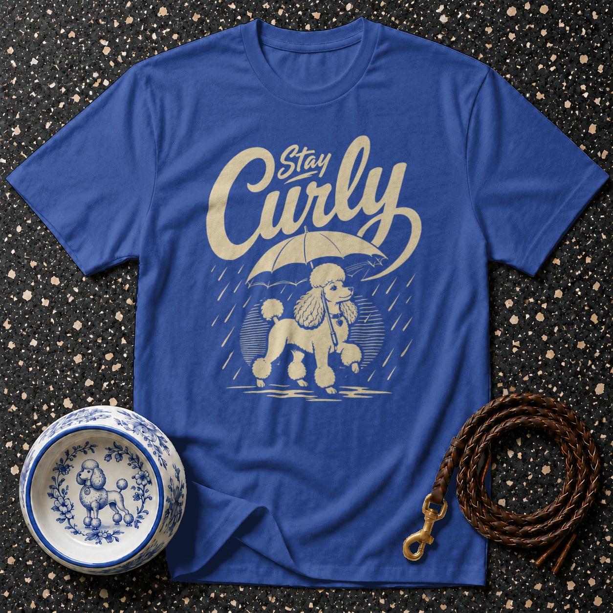 Blue t-shirt with cream poodle and umbrella graphic, and "Stay Curly" text.
