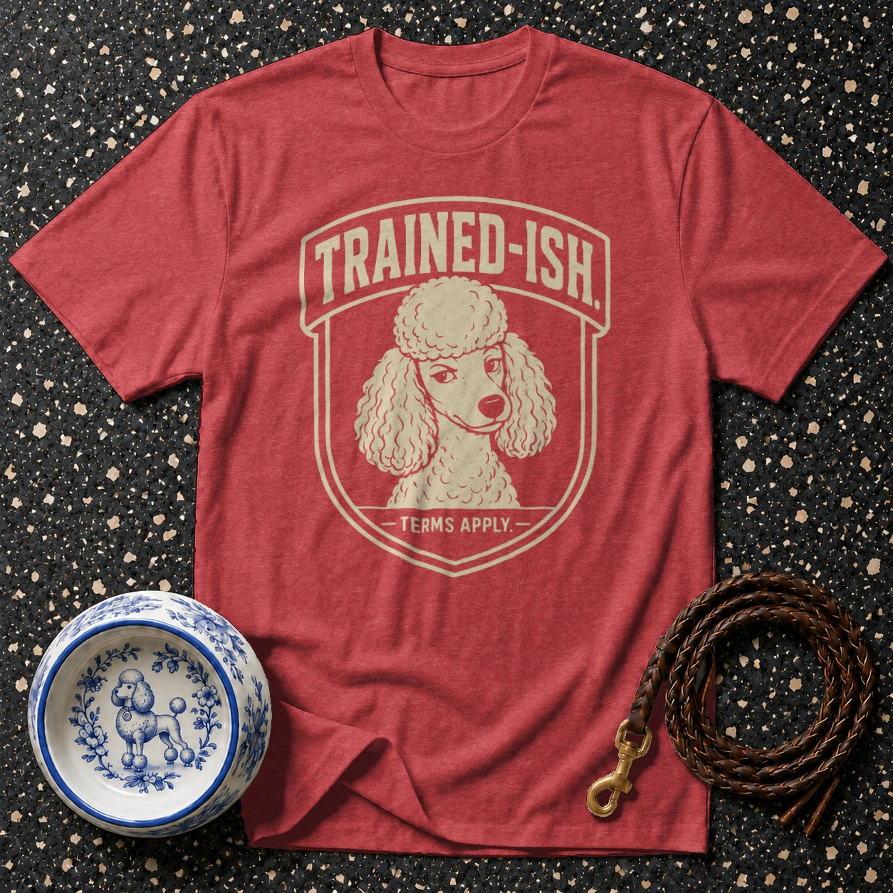Red t-shirt with "TRAINED-ISH TERMS APPLY." and poodle graphic, dog bowl, and leash.