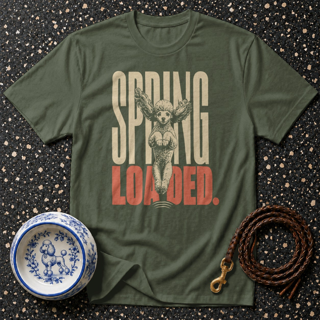 Green t-shirt with "SPRING LOADED" text and a winged poodle graphic.