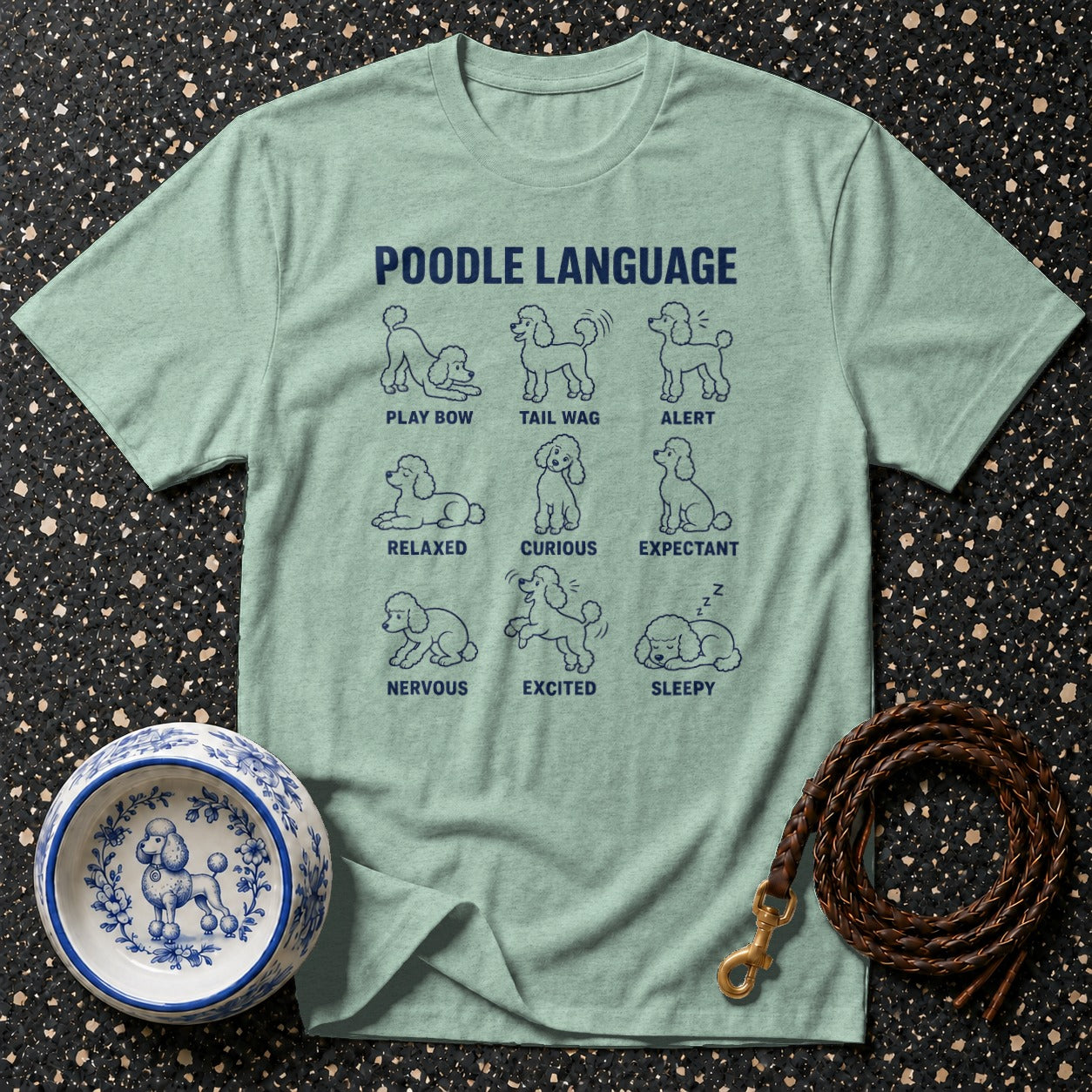 Light blue t-shirt with "Poodle Language" text and nine illustrations of poodles showing various moods.