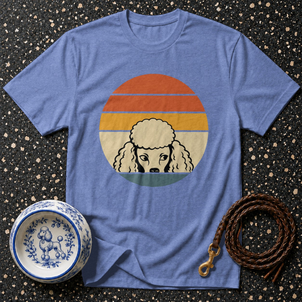 Blue t-shirt with vintage sunset and poodle graphic, dog bowl, and leash.