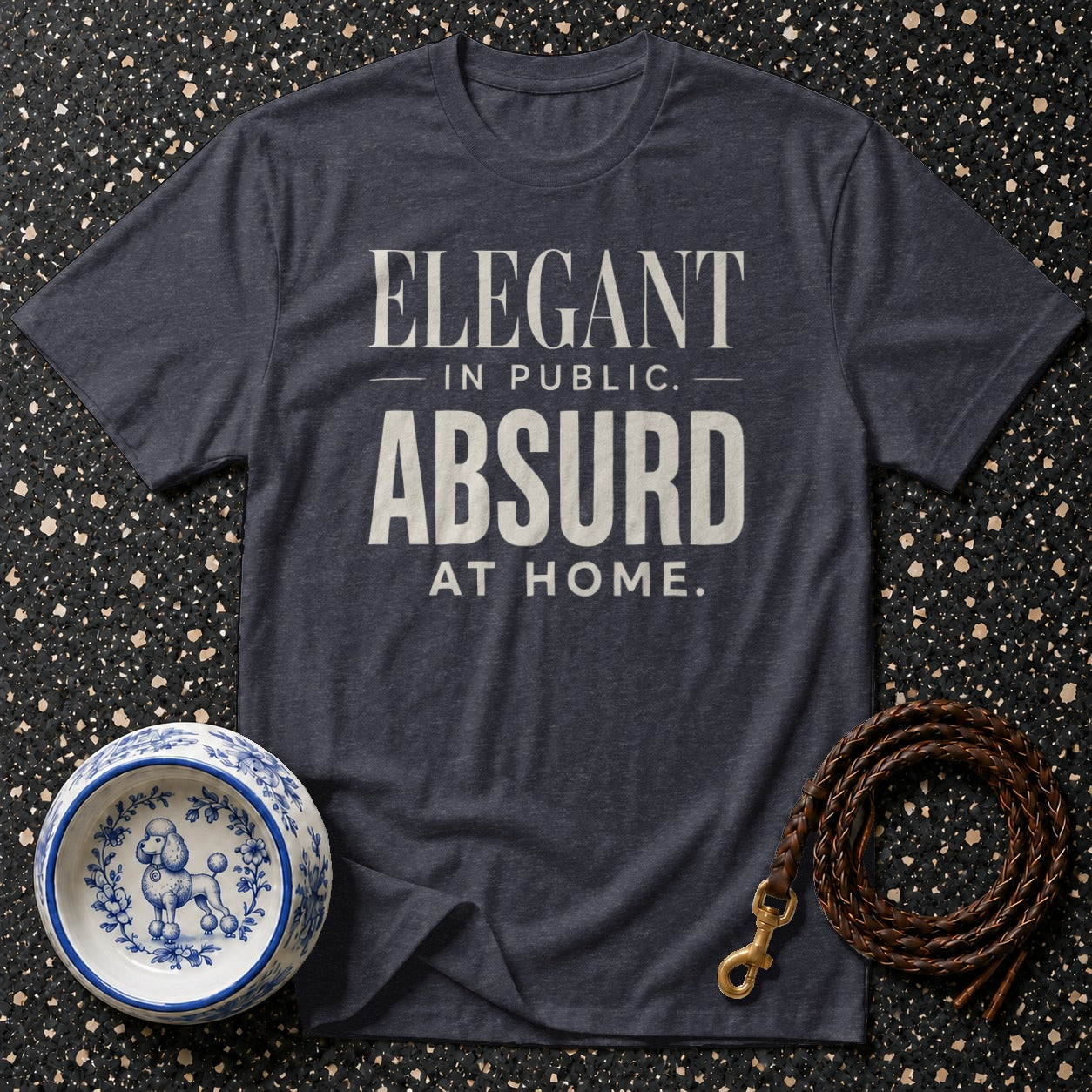 Dark gray t-shirt with "Elegant in public. Absurd at home." text.