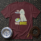 Maroon t-shirt with a poodle and text "The puzzle was brief".