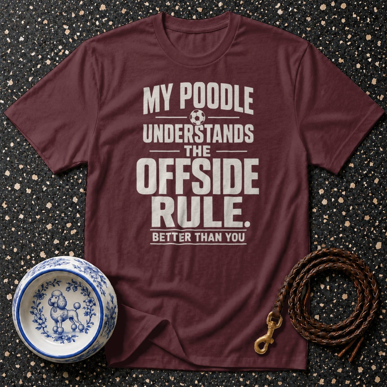 Maroon t-shirt with "My poodle understands the offside rule better than you" text.
