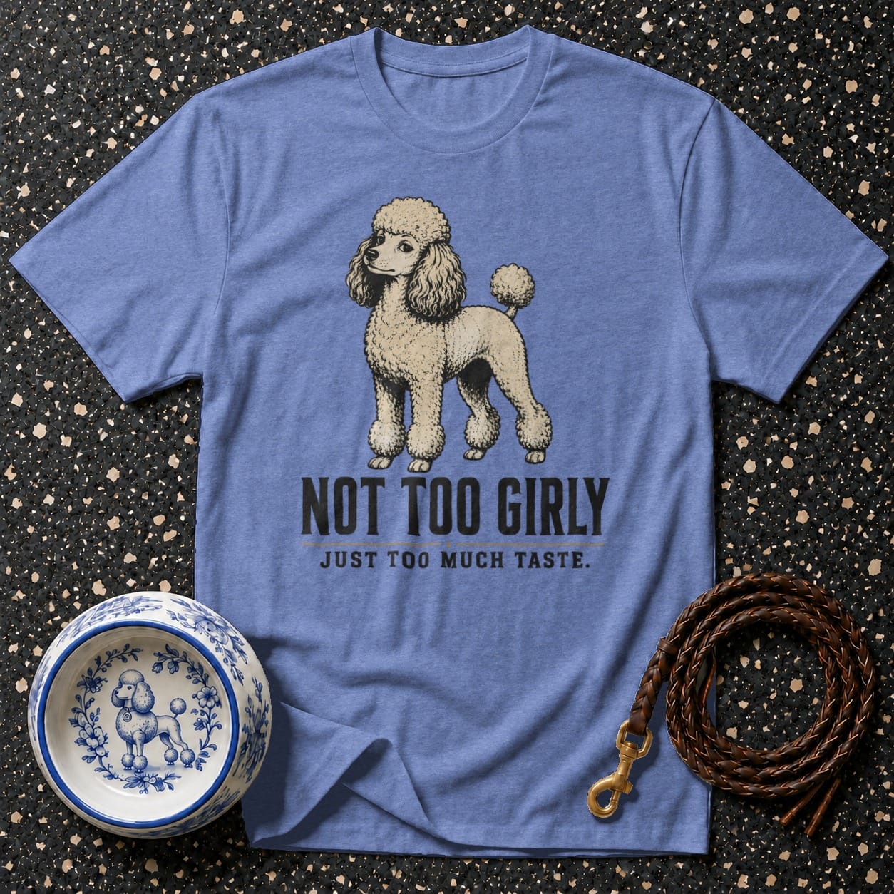 Blue t-shirt with poodle graphic and text "NOT TOO GIRLY JUST TOO MUCH TASTE."