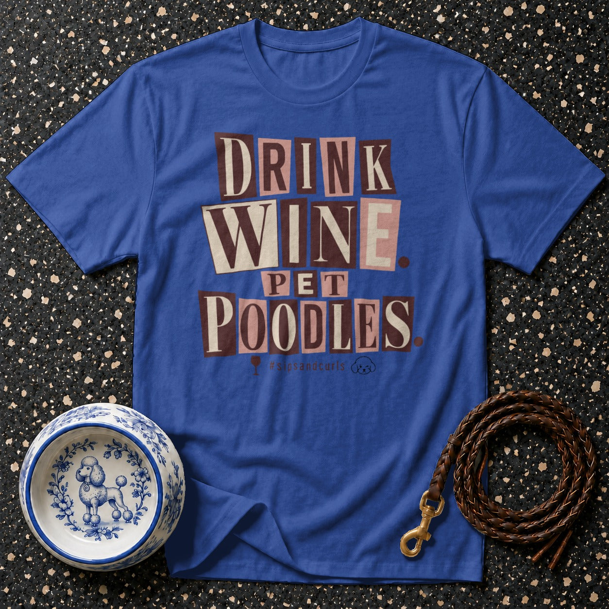 Blue t-shirt with "DRINK WINE PET POODLES" text and poodle imagery.