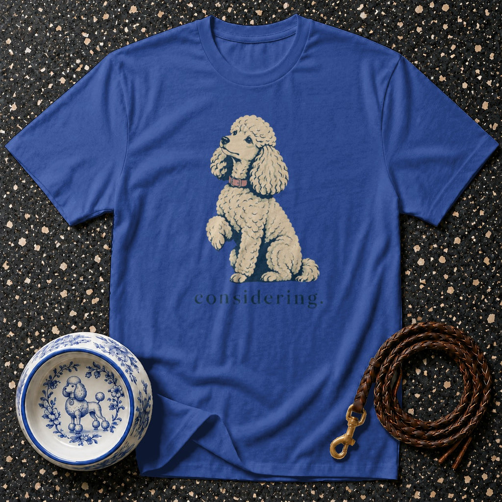 Blue t-shirt with a poodle illustration and the word "considering."